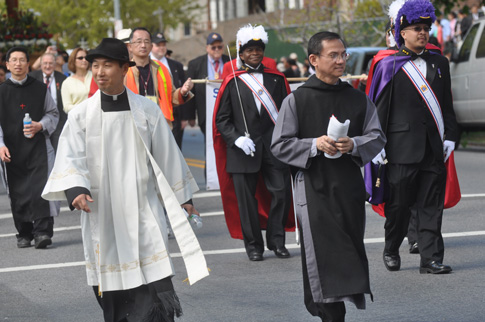 Marching through the streets of Flushing, Knights participate in a procession of Our Lady of She-Shan at St. John Vianney parish in this 2013 file photo. (Photo © Ed Wilkinson)