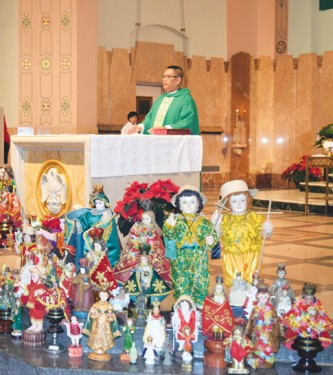 Father Adolfo Novio stands by the altar, which is surrounded by statues of the Santo Niño. (Photos by Maria-Pia Negro Chin)