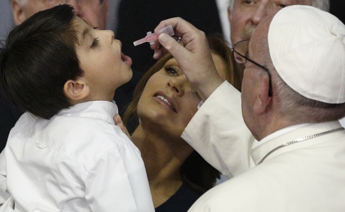 Pope Francis gives a vaccine to a boy held by Mexico's first lady Angelica Rivera during a visit to the Federico Gomez Children's Hospital of Mexico in Mexico City Feb. 14. (CNS photo/Paul Haring) 