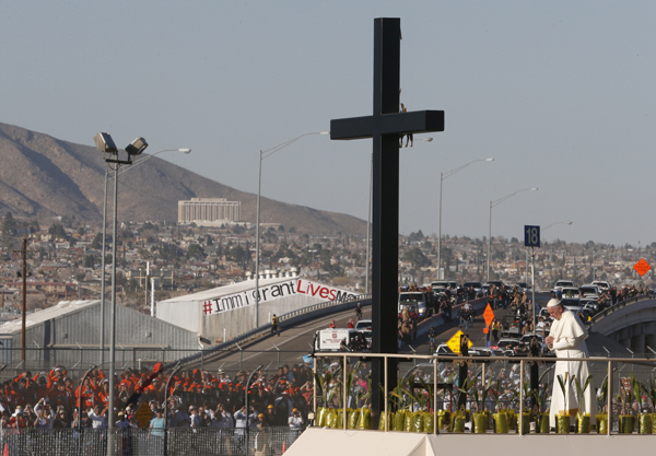 Pope Francis prays at a cross on the border with El Paso, Texas, before celebrating Mass at the fairgrounds in Ciudad Juarez, Mexico, Feb. 17. Photo © Catholic News Service/Paul Haring