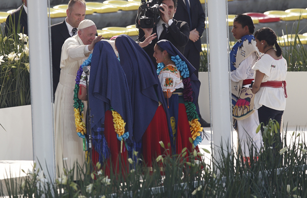  The Holy Father greets girls in traditional dress during a meeting with young people at the Jose Maria Morelos Pavon Stadium in Morelia, Feb. 16. Photos © Catholic News Service/Paul Haring