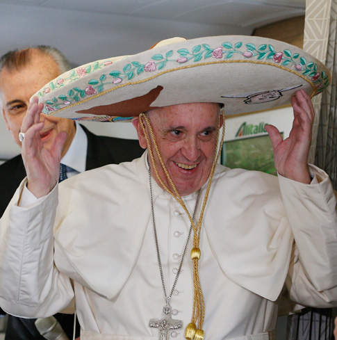 Pope Francis tries on a sombrero while meeting journalists aboard his flight to Havana Feb. 12. Traveling to Mexico for a six-day visit, the pope is stopping briefly in Cuba to meet with Russian Orthodox Patriarch Kirill of Moscow at the Havana airport. (CNS photo/Paul Haring) 