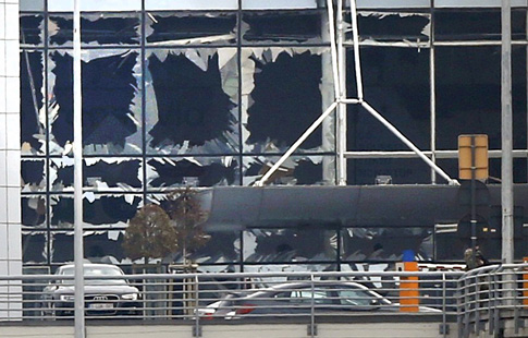 Broken windows are seen at the scene of explosions at Zaventem airport near Brussels March 22. (CNS photo/Francois Lenoir, Reuters) 