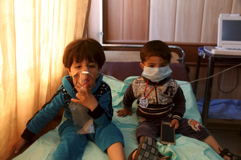 Children receive oxygen at a hospital in Taza, Iraq, March 9, after Islamic State militants fired mortar shells and rockets filled with "poisonous substances" into their village. (CNS photo/Stringer, Reuters) 
