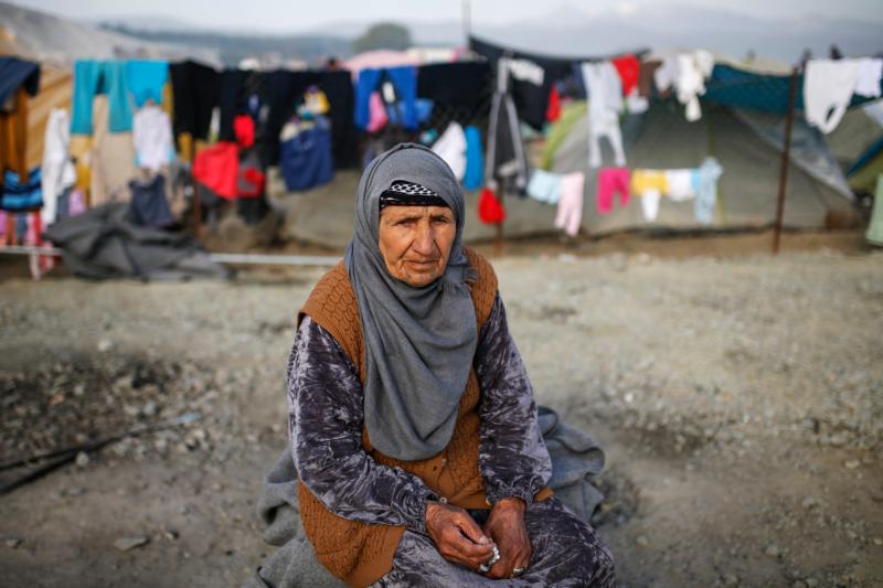 An elderly woman sits at a makeshift camp for migrants and refugees April 6 at the Greek-Macedonian border near the village of Idomeni, Greece. Pope Francis will go to the Greek island of Lesbos April 16 with Orthodox leaders to highlight the plight of refugees. (CNS photo/Marko Djurica, Reuters) See POPE-GREECE-REFUGEES April 7, 2016.