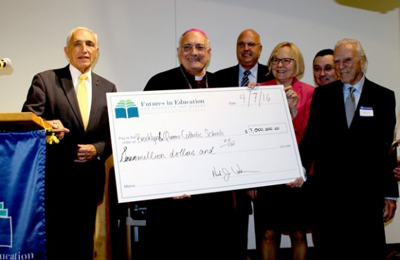 Joined by Futures in Education board members and staff, Bishop Nicholas DiMarzio presents a check to Dr. Thomas Chadzutko representing some financial assistance Futures is giving diocesan Catholic schools this year. From left, Joseph Sciame, emcee; Bishop DiMarzio; Chadzutko; Mary Jane McCartney; Nick Vendikos and John Loconsolo. 