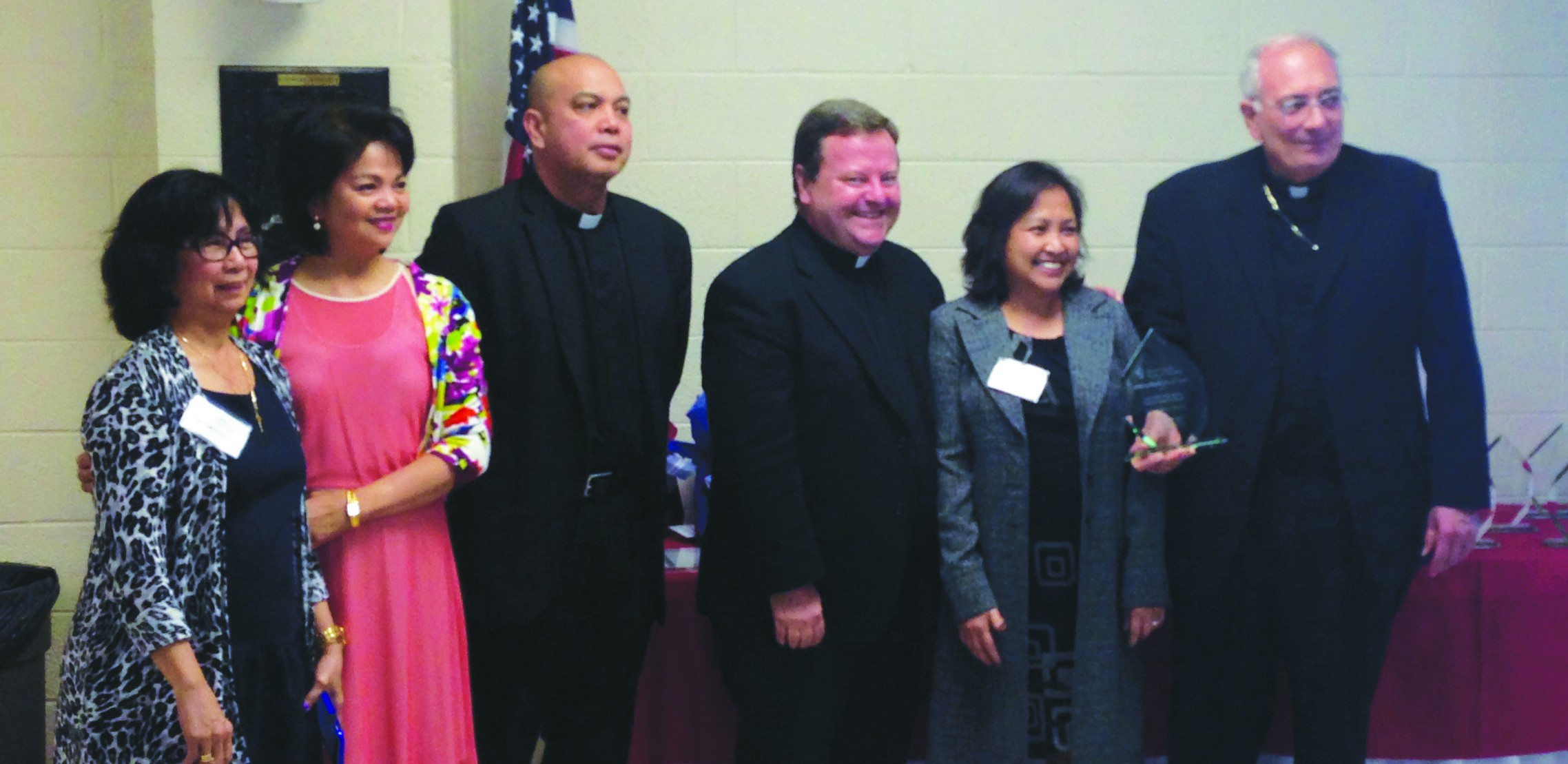  Bishop Nicholas DiMarzio congratulates the parishioners of Our Lady of the Snows Church, N. Floral Park, and Father Kevin F. McBrien, pastor, third from right, on ranking among the top Queens parishes for blood donation collections. 