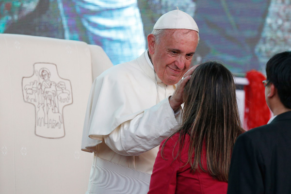 Pope Francis greets a young woman during a meeting with youths in Asuncion, Paraguay, in this July 12, 2015, file photo. Pope Francis' postsynodal apostolic exhortation on the family, "Amoris Laetitia" ("The Joy of Love"), was released April 8. (CNS photo/Paul Haring)