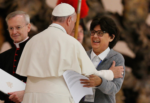 Pope Francis embraces Sister Carmen Sammut, a Missionary Sister of Our Lady of Africa and president of the International Union of Superiors General, during an audience with the heads of women's religious orders in Paul VI hall at the Vatican May 12. During a question-and-answer session with members of the IUSG, the pope said he was willing to establish a commission to study whether women could serve as deacons. (CNS photo/Paul Haring)