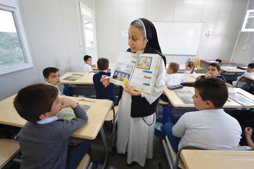 Dominican Sister Lemia Atala instructs students at the Al Bishara School in Ankawa, Iraq. The Islamic State group displaced the students and the Dominican Sisters in 2014. (Photo © Catholic News Service/ Paul Jeffrey)