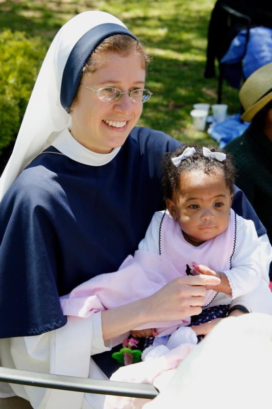Sister Talitha Guadalupe, S.V., holds 6-month-old Esther at a Mother’s Day celebration May 8.