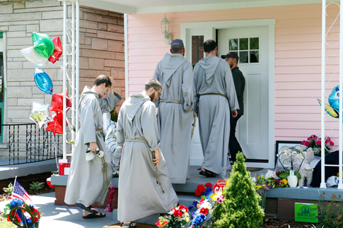 Franciscan Friars of the Renewal from New York pay their respects at the childhood home of boxing legend Muhammad Ali June 5 in Louisville, Ky. Ali died June 3 at age 74 after a long battle with Parkinson’s disease. (Photo © Catholic News Service/ John Sommers II, Reuters)