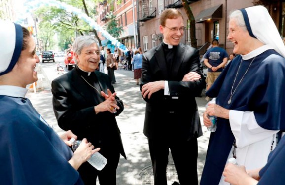 Bishop Salvatore R. Matano, left, of Rochester, N.Y., and Father Daniel White chat with Sister Mariam Caritas, immediate left, and Mother Agnes Mary Donovan, superior general of the Sisters of Life, during a block party in New York City June 1 celebrating the religious community’s 25th anniversary. (Photos: Gregory A. Shemitz) 