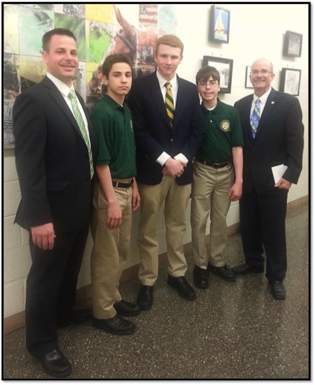 Patrick Harris, assistant principal, left, and Edward Burns, principal, at right, pose with three of the five winners before distributing prizes. 