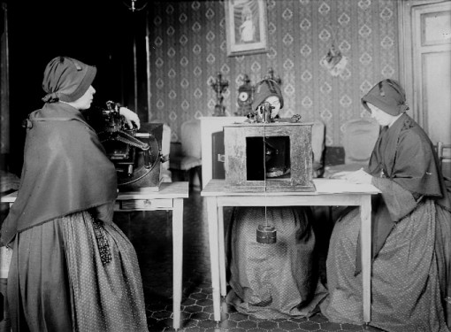 Members of the Sisters of the Child Mary use microscopes to review glass plates as they measure star positions for a collaborative photography project the Vatican participated in to catalogue the stars and create a photographic map of the heavens. At right a member of the order records star coordinates in a ledger. Sisters Emilia Ponzoni, Regina Colombo, Concetta Finardi and Luigia Panceri worked on recording star coordinates from glass plates between 1910 and 1921. (Photo: Catholic News Service/courtesy Vatican Observatory) 