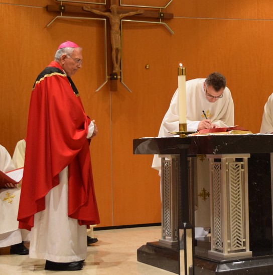 Father Blicharz signs his documents of incardination. Photos [c] Antonina Zielinska