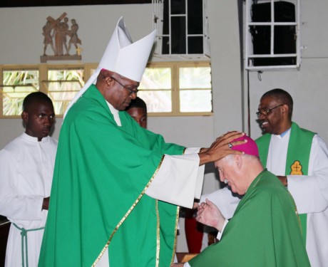 At a Farewell Mass in his honor, Bishop Tiedemann receives a blessing from Kingston Archbishop Kenneth Richards on July 3 at St. Paul of the Cross Cathedral, Mandeville, Jamaica.