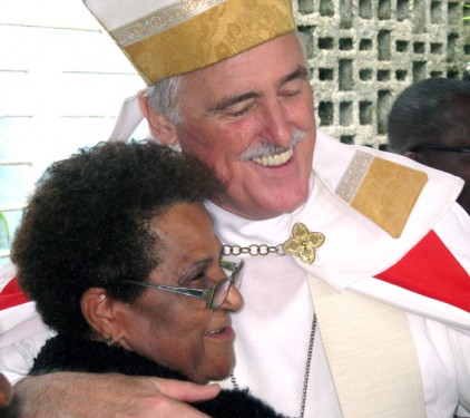 Bishop Tiedemann embraces a parishioner after Mass at St. Paul of the Cross Cathedral, Mandeville, Jamaica.