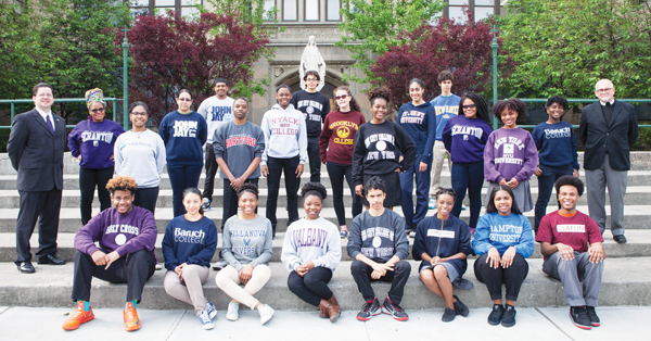 Graduating seniors, Class of 2015, wear the sweatshirts of the colleges they are attending this fall. They are shown with school principal, Ed Bolan, left, and school president, Brother Dennis Cronin, F.S.C., right.