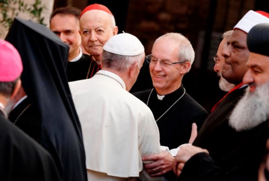 Pope Francis greets Anglican Archbishop Justin Welby of Canterbury, England, spiritual leader of the Anglican Communion, above, as he arrives for an interfaith peace gathering at the Basilica of St. Francis in Assisi, Italy, Sept. 20. (Photos: Catholic News Service/Paul Haring)