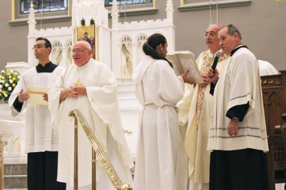 Bishop Nicholas DiMarzio installs Father Raymond Roden as pastor.