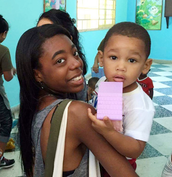 St. Edmund student Melissa Nereus holds one of the children she met in Cuba.
