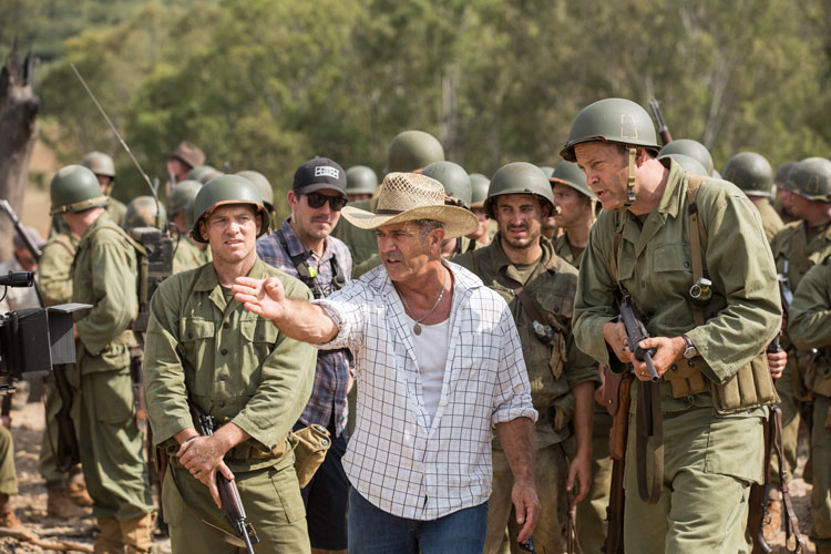 Director Mel Gibson, center, is seen on the set of “Hacksaw Ridge.” The movie marks Gibson’s return to the director’s chair after a 10-year absence. (Photo: Catholic News Service/Lionsgate) 