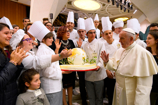 Pope Francis accepts a birthday cake from chefs during his general audience in Paul V hall at the Vatican Dec. 14. The pope turned 80 Sept. 17. 