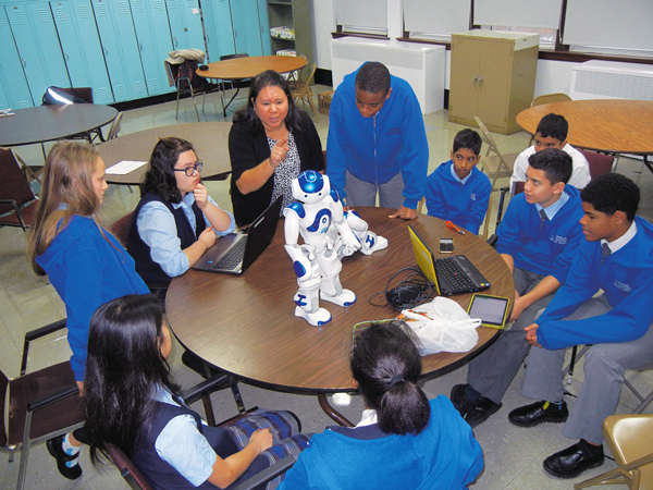  Robotics instructor Mariella Reiman gives a lesson to seventh and eighth graders at St. Nicholas of Tolentine Catholic Academy, Jamaica. Also seen are the wonder bots, Dot and Dove. Photos © Melissa Enaje