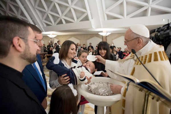 Pope Francis celebrates the baptism of 13 babies from earthquake zones in Italy in the chapel of the Domus Sanctae Marthae at the Vatican Jan. 14. (Photo: Catholic News Service/L'Osservatore Romano, handout)