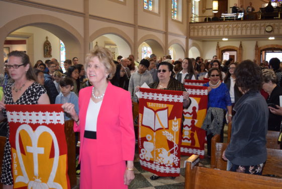 carrying banners into church