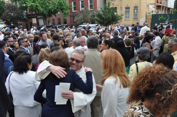 Deacon Kevin McLaughlin, foreground, and others are congratulated after the Mass.