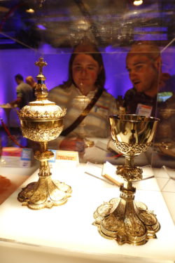 Participants in World Communications Day view some of the diocesan artifacts, such as the chalices used by Brooklyn’s second Bishop, Charles E. McDonnell, that were on display in the exhibit hall. Photo Greg Shemitz