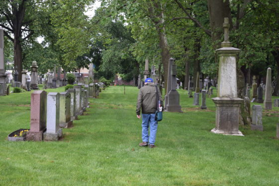 oldtimer walks through cemetery
