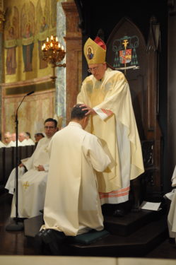Bishop Nicholas DiMarzio lays hands on the head of Thomas E. Jorge as he ordains him to the permanent diaconate for the Diocese of Brooklyn 