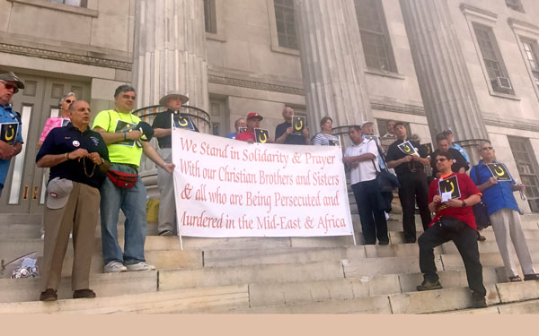 Showing their unity with Christians who are being persecuted in the Middle East and Africa, local Knights of Columbus, along with family and friends, along with several  priests conducted a Day of Witness on the steps of Brooklyn Borough Hall, July 26.
