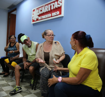 People affected by Hurricane Maria wait to receive food aid in the headquarters of Caritas Puerto Rico Oct. 20 in San Juan. (CNS photo/Bob Roller)