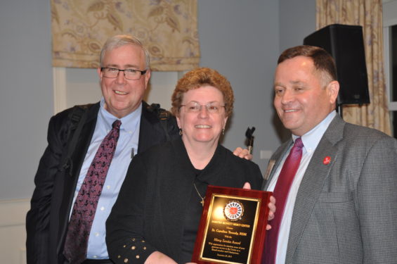  Sister Caroline receives the Mercy Service Award from Morgan and Dennis Gallagher, board member.