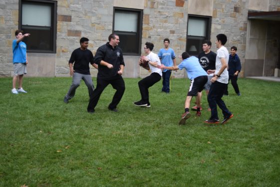 Father Christopher Bethge, exhibiting his athletic skills during a football game with students from his alma mater, Cathedral Prep.