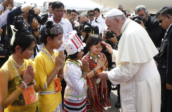 Pope Francis greets children as he arrives at Yangon International Airport in Yangon, Myanmar, Nov. 27. The pope is making a six-day visit to Myanmar and Bangladesh. (CNS photo/Paul Haring)