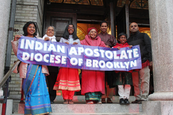 Representatives of the Indian Ministry pose for a photo on the church steps.