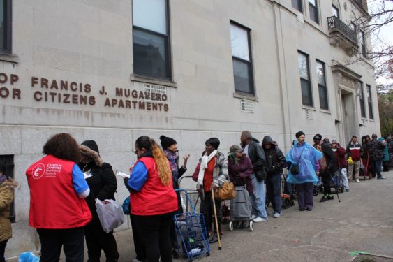Catholic Charities personnel check in guests for the annual turkey distribution at the Bishop Mugavero Senior Apartments in Fort Greene.