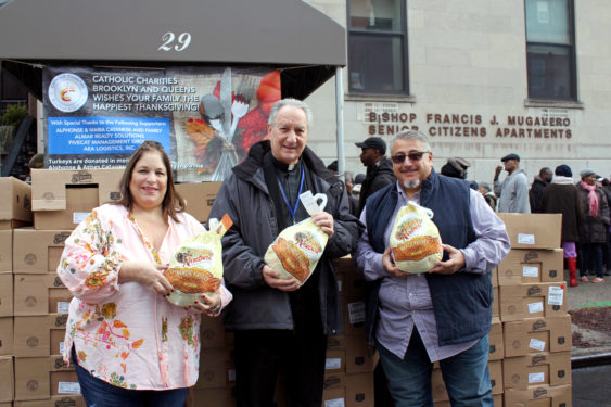  Alphonse and Maria Catanese of Belle Harbor helped sponsor Catholic Charities’ turkey giveaway for Thanksgiving. They are seen above with Msgr. Al LoPinto, diocesan vicar for human services, and chief executive officer for Catholic Charities.