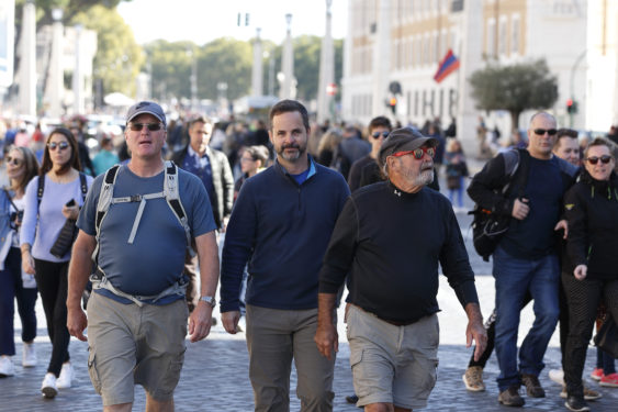 Father Vincent Gilmore, tour leader Bret Thoman  and Deacon Terrance Marcell walk toward the Vatican as they follow the historic pilgrimage route of St. Francis from Assisi to Rome Oct. 23. (CNS photo/Paul Haring)