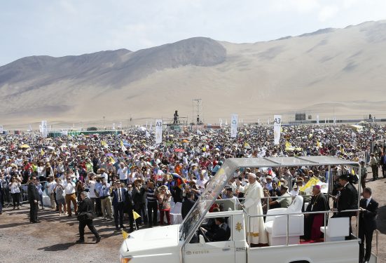 Pope Francis greets the crowd before celebrating Mass at Lobito beach in Iquique, Chile, Jan. 18. (CNS photo/Paul Haring)