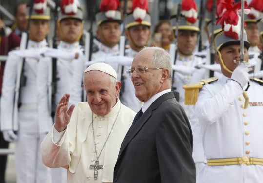 Pope Francis waves as he walks past an honor guard with Peruvian President Pedro Pablo Kuczynski as he arrives at the Jorge Chavez International Airport in Lima, Peru, Jan. 18. (CNS photo/Paul Haring) 