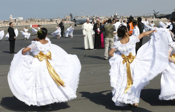 Pope Francis watches dancers perform upon his arrival at the international airport in Trujillo, Peru, Jan. 20. (CNS photo/Paul Haring)