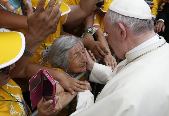Pope Francis greets a blind woman who is 99 years old along the parade route in Trujillo, Peru, Jan. 20. (CNS photo/Paul Haring)