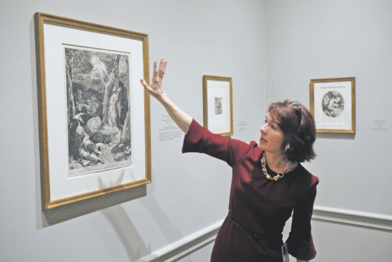 Ginger Hammer, an assistant curator at the National Gallery of Art in Washington, describes details in a painting during a media preview of the “Heavenly Earth: Images of Saint Francis at La Verna” exhibit. Photo © Catholic News Service/ Bob Roller