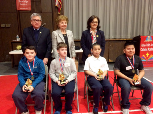 Winners of regional Religion Bees – Queens parish winners in grades three through five. Pictured with Barbara McArdle from the diocesan Catholic Schools Office, Theodore Musco, diocesan secretary for evangelization and catechesis and Nelsa Elias, facilitator of catechetical program outreach.